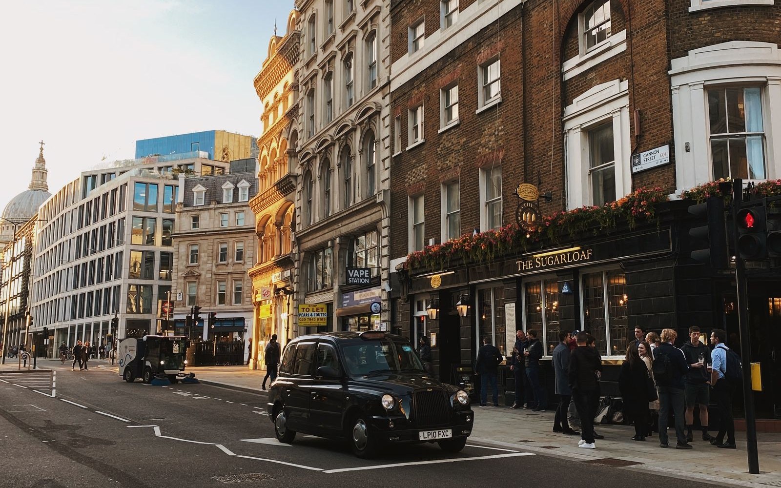 UK city street with a black taxi